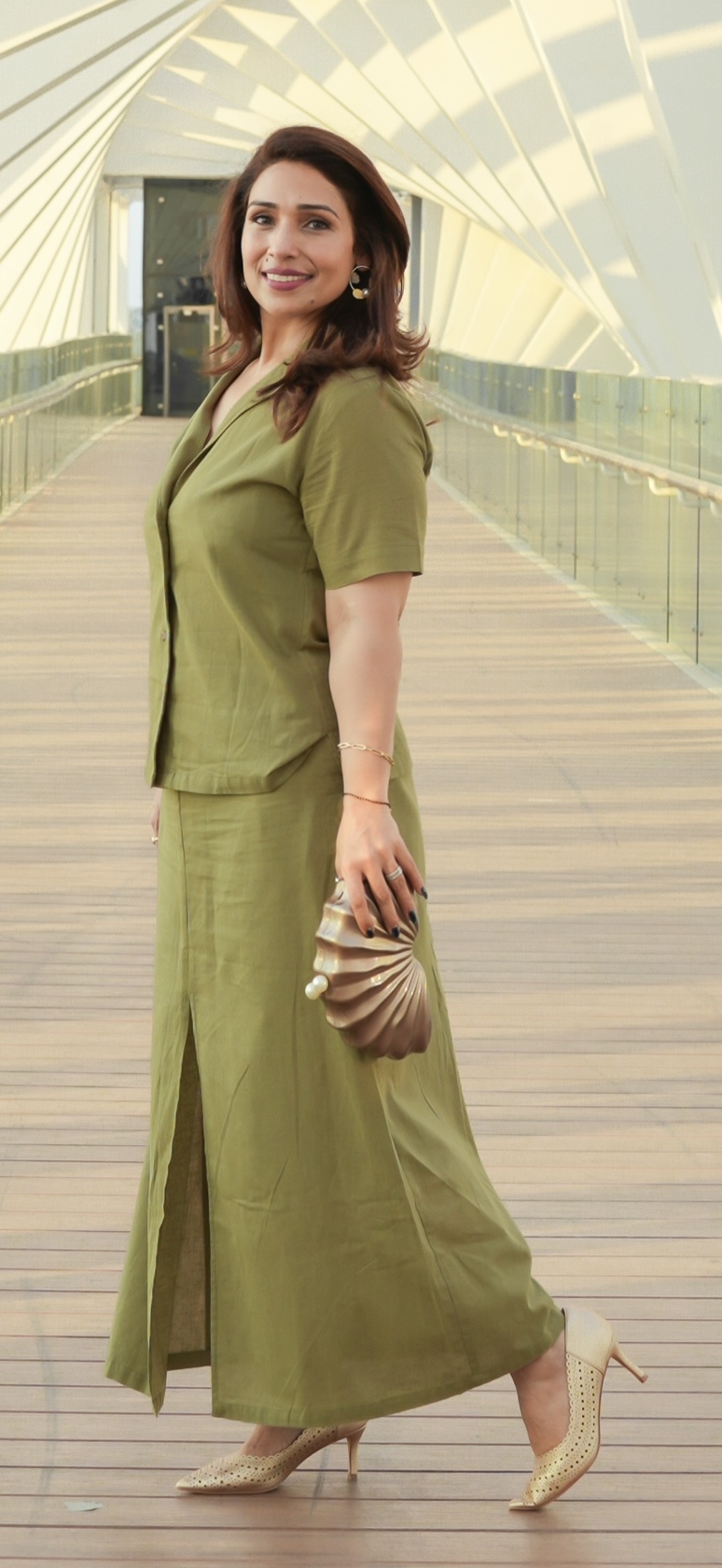 Olive shirt and matching skirt styled with a shell-shaped clutch